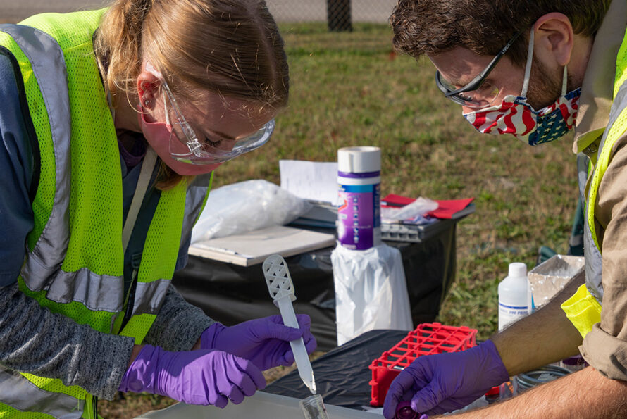 Photo of Erin Kelly and Andrew Putt, University of Tennessee Knoxville graduate students, process sediment samples from CPT drilling.